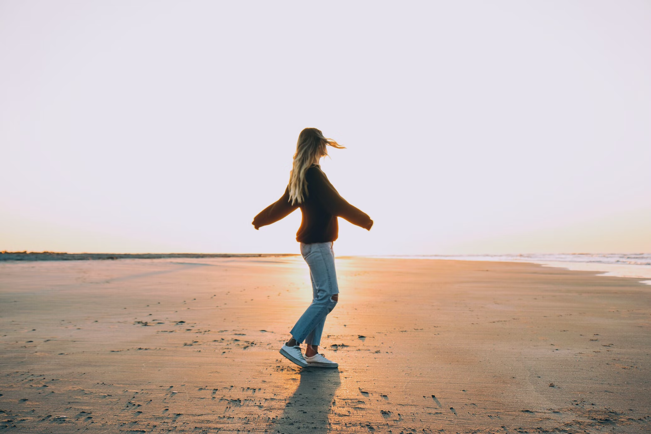 A woman walking on the beach.